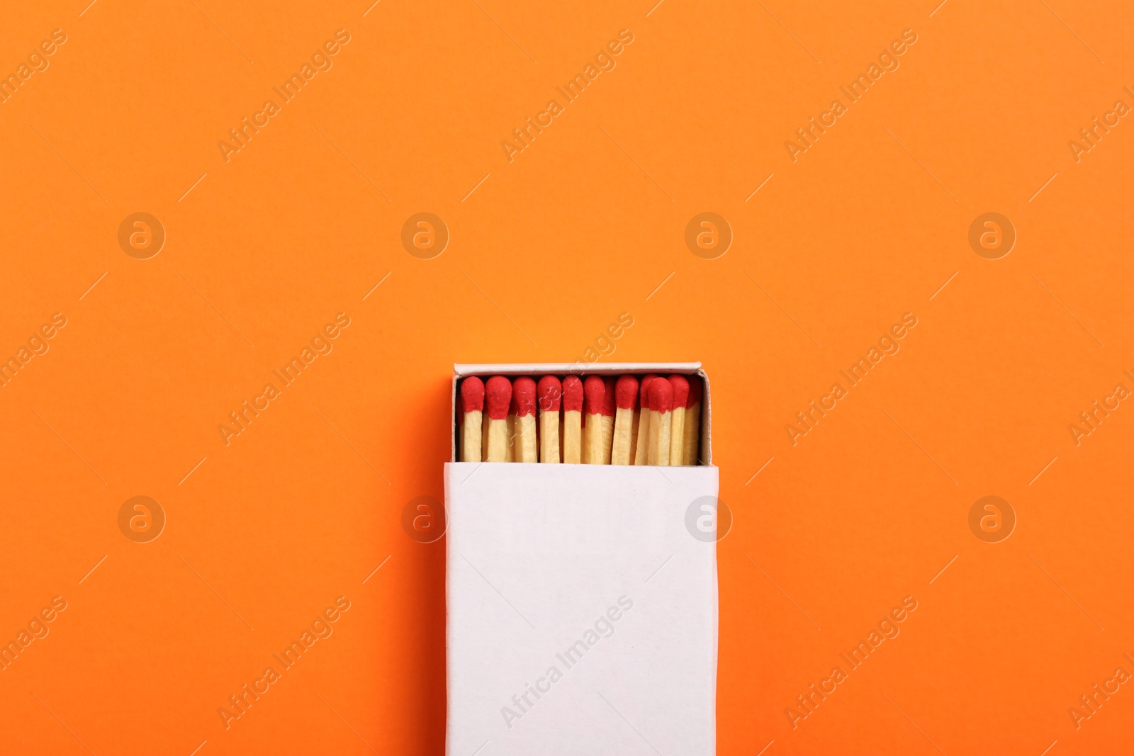 Matches in box on orange background, top view. Mockup for design Photo of Matches in box on orange background, top view. Mockup for design