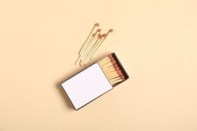 Photo of Matches and box on beige background, flat lay. Mockup for design