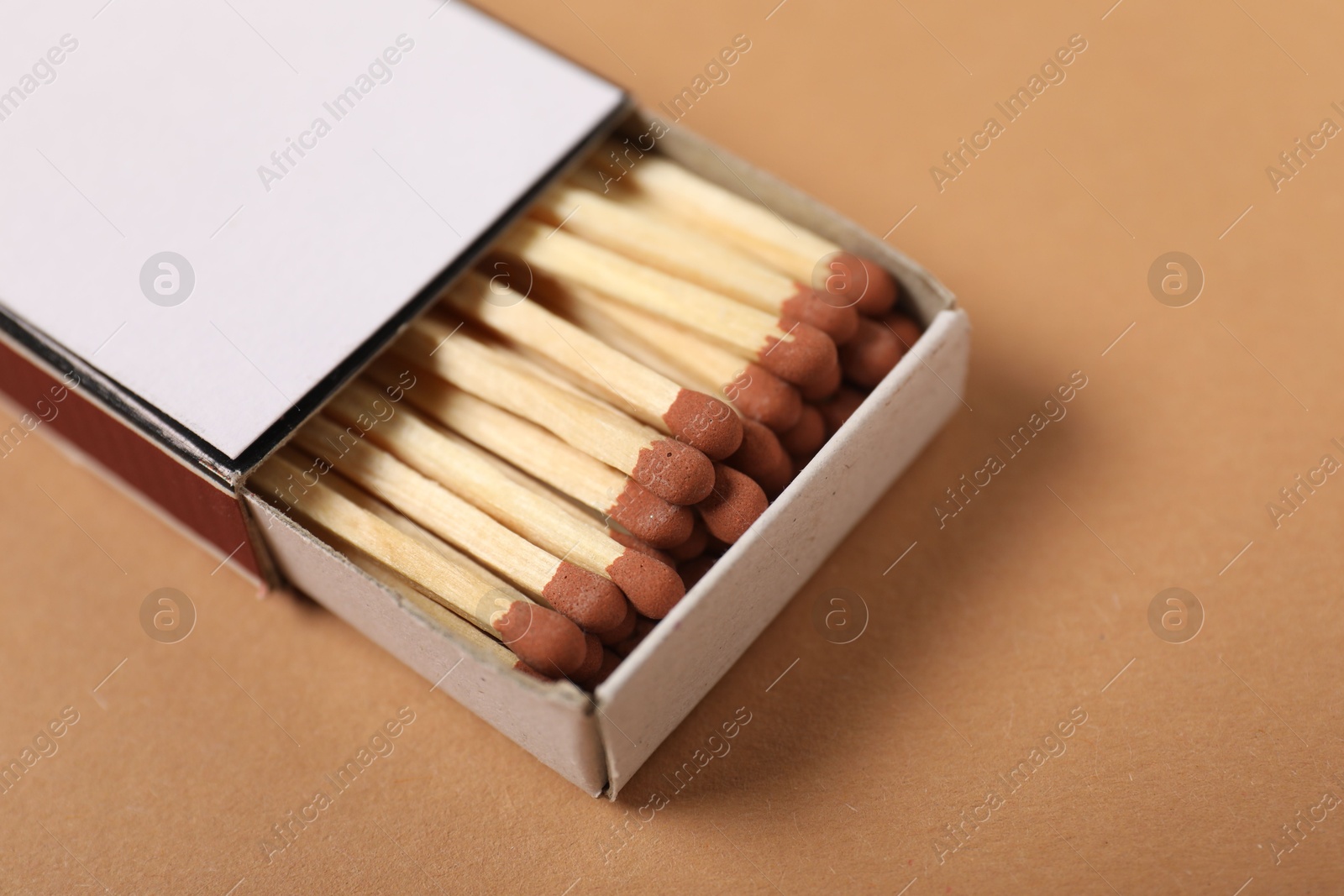 Matches in box on beige background, closeup Photo of Matches in box on beige background, closeup