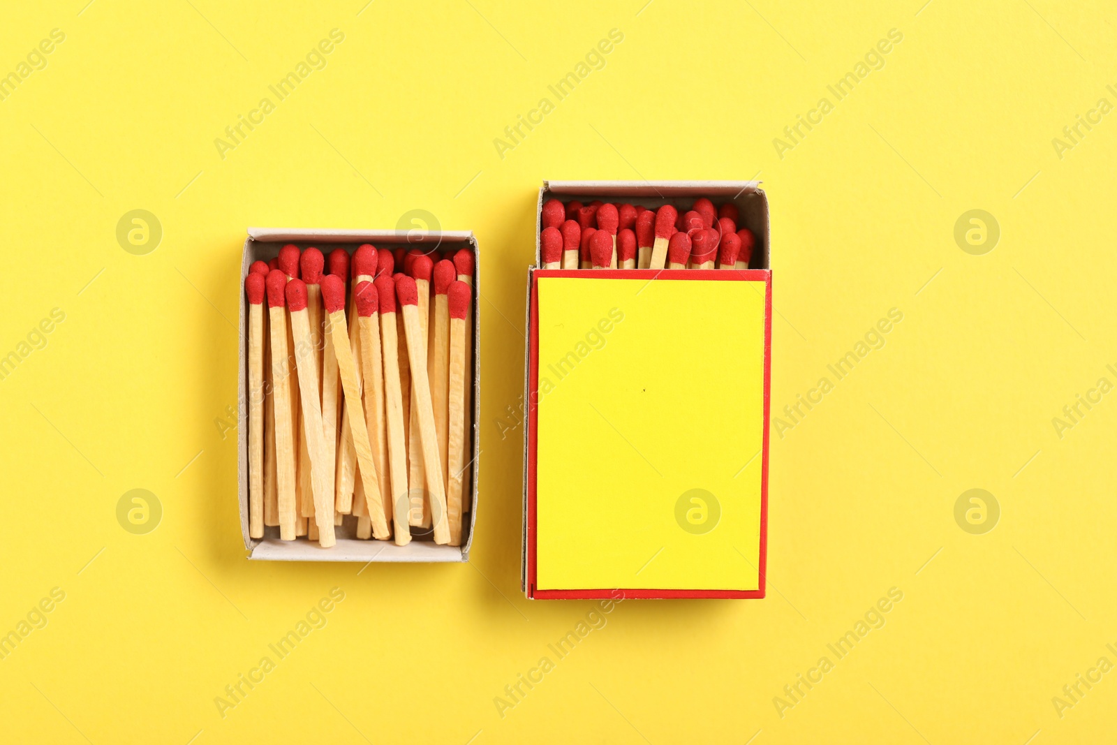 Matches and boxes on yellow background, flat lay. Mockup for design Photo of Matches and boxes on yellow background, flat lay. Mockup for design