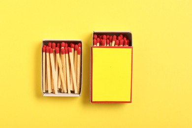 Photo of Matches and boxes on yellow background, flat lay. Mockup for design