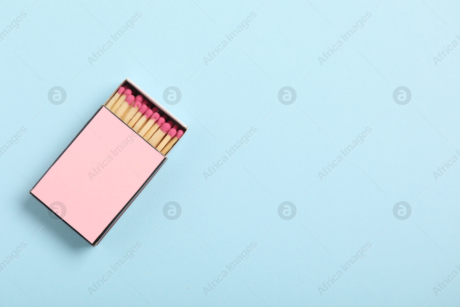 Matches in box on light blue background, top view. Mockup for design Photo of Matches in box on light blue background, top view. Mockup for design