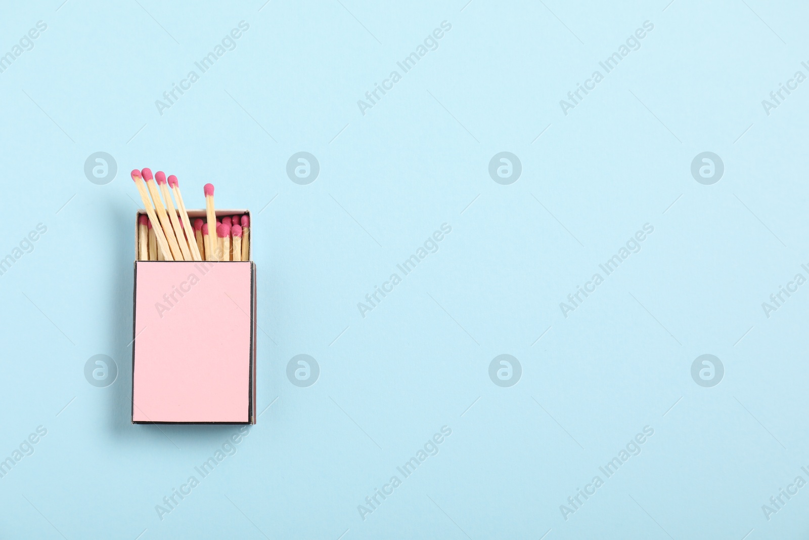 Matches in box on light blue background, top view. Mockup for design Photo of Matches in box on light blue background, top view. Mockup for design