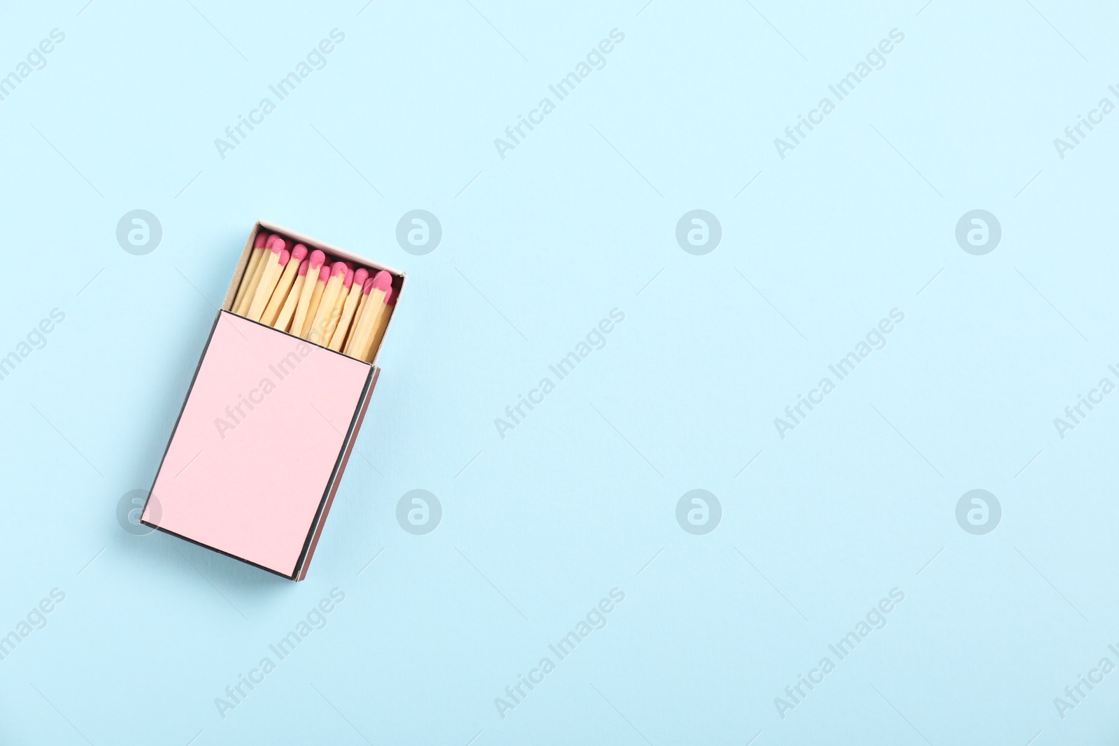 Matches in box on light blue background, top view. Mockup for design Photo of Matches in box on light blue background, top view. Mockup for design