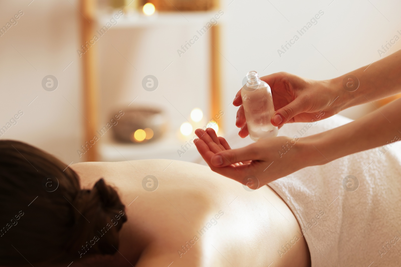 Woman receiving back massage with oil in spa salon, closeup Photo of Woman receiving back massage with oil in spa salon, closeup