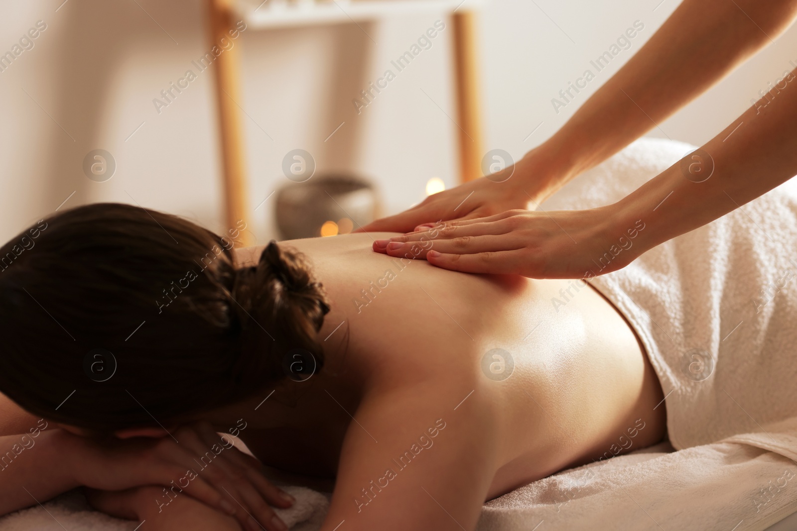 Woman receiving back massage with oil in spa salon Photo of Woman receiving back massage with oil in spa salon