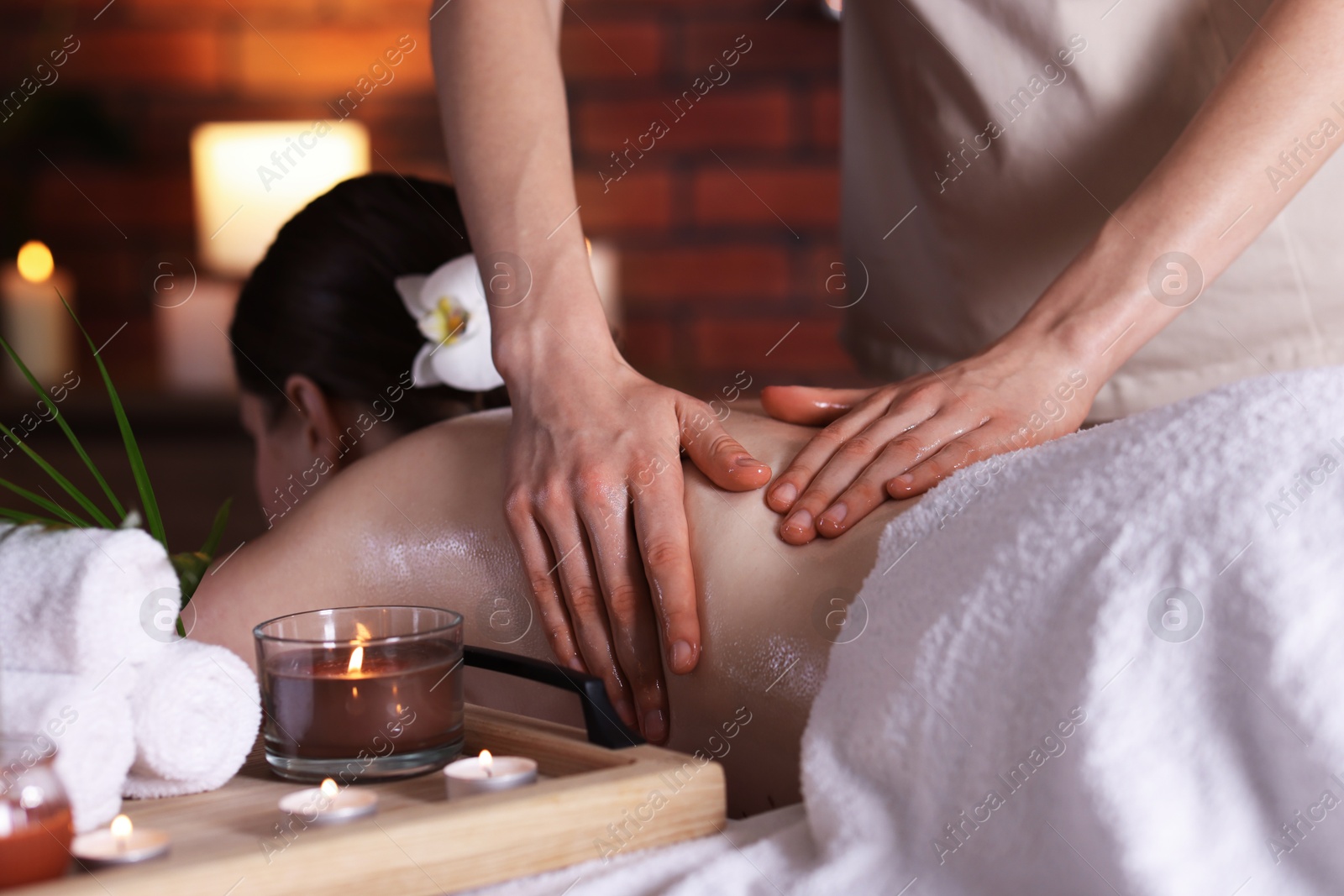 Woman receiving back massage with oil in spa salon Photo of Woman receiving back massage with oil in spa salon