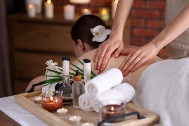 Photo of Woman receiving back massage with oil in spa salon