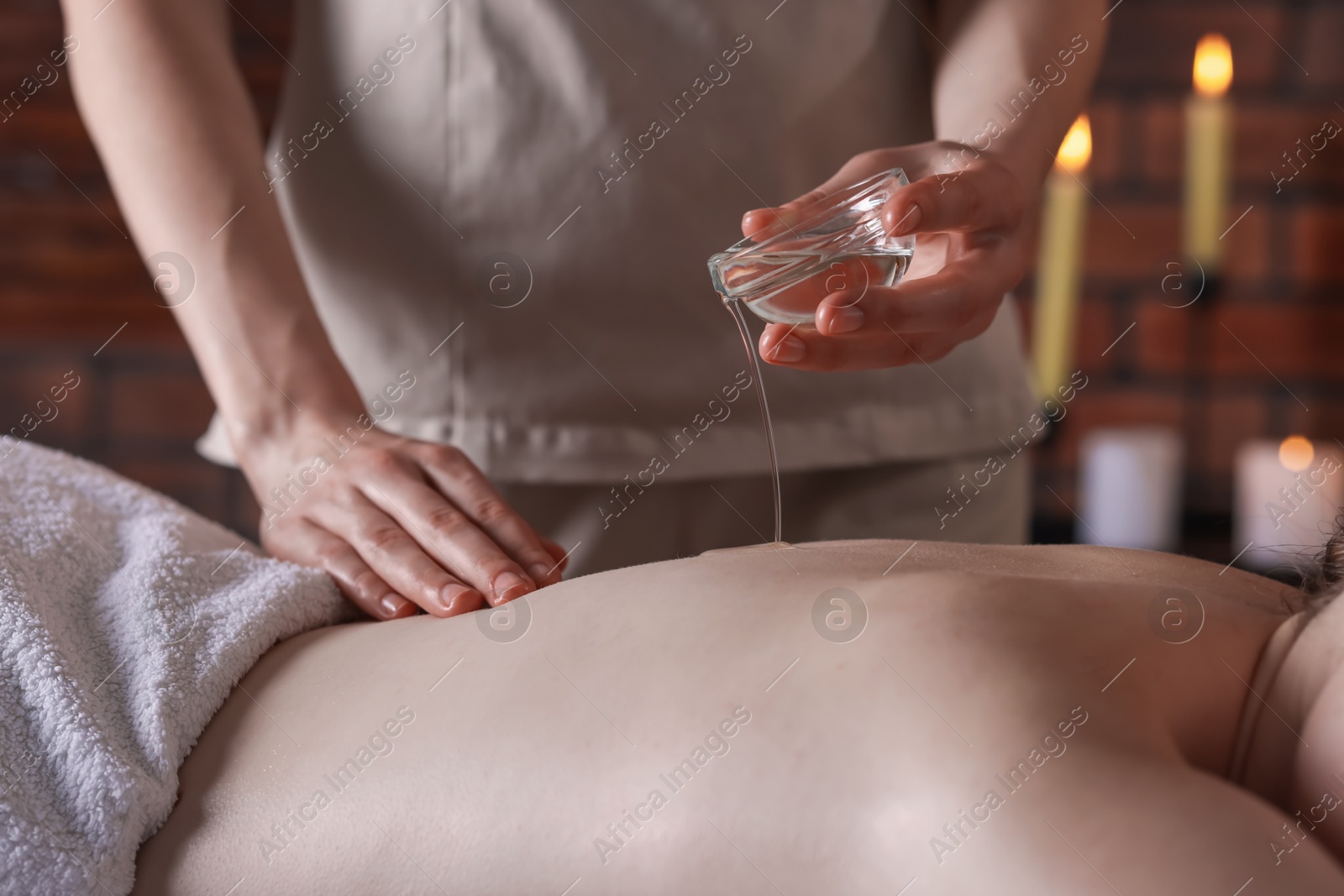 Woman receiving back massage with oil in spa salon, closeup Photo of Woman receiving back massage with oil in spa salon, closeup