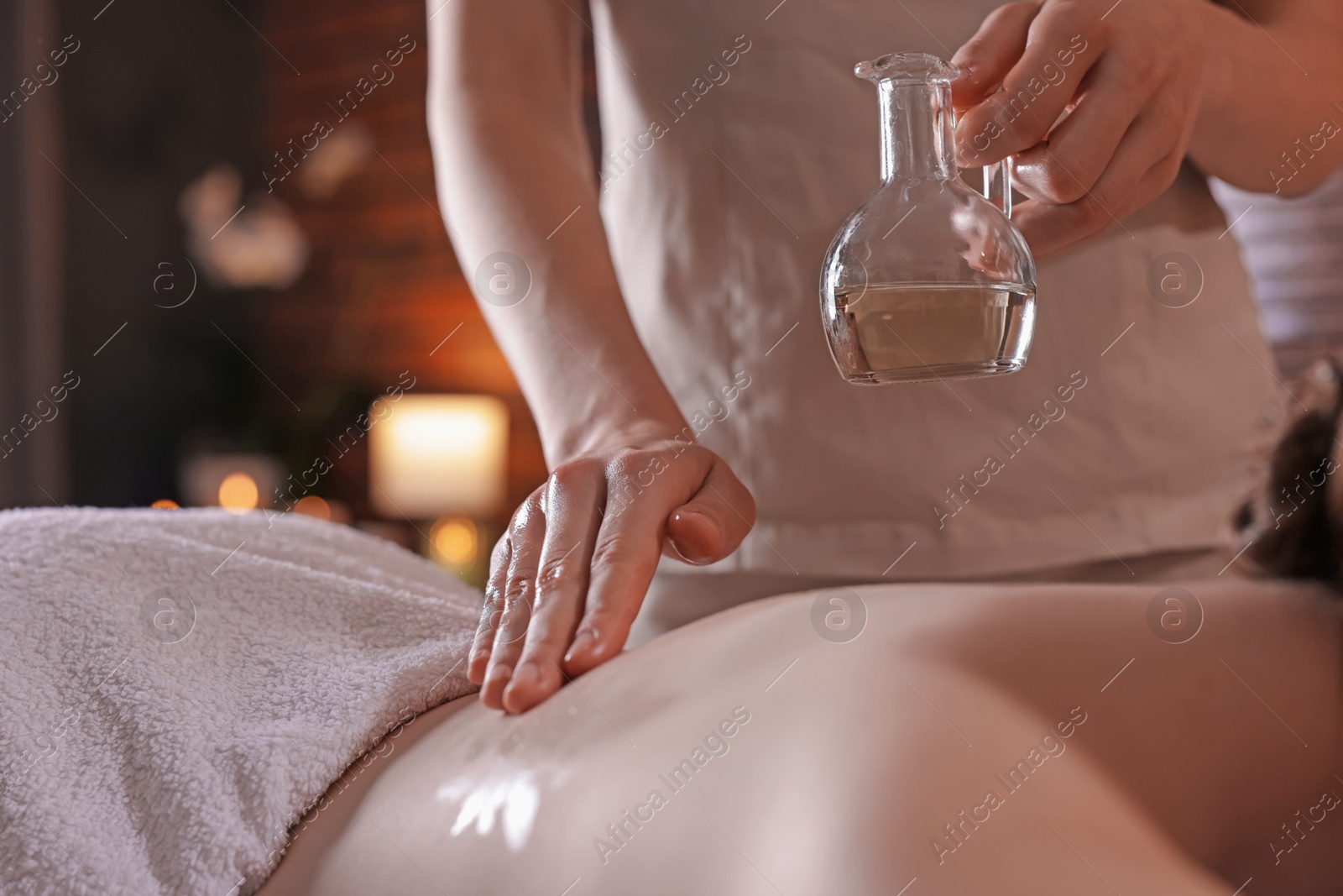 Woman receiving back massage with oil in spa salon, closeup Photo of Woman receiving back massage with oil in spa salon, closeup