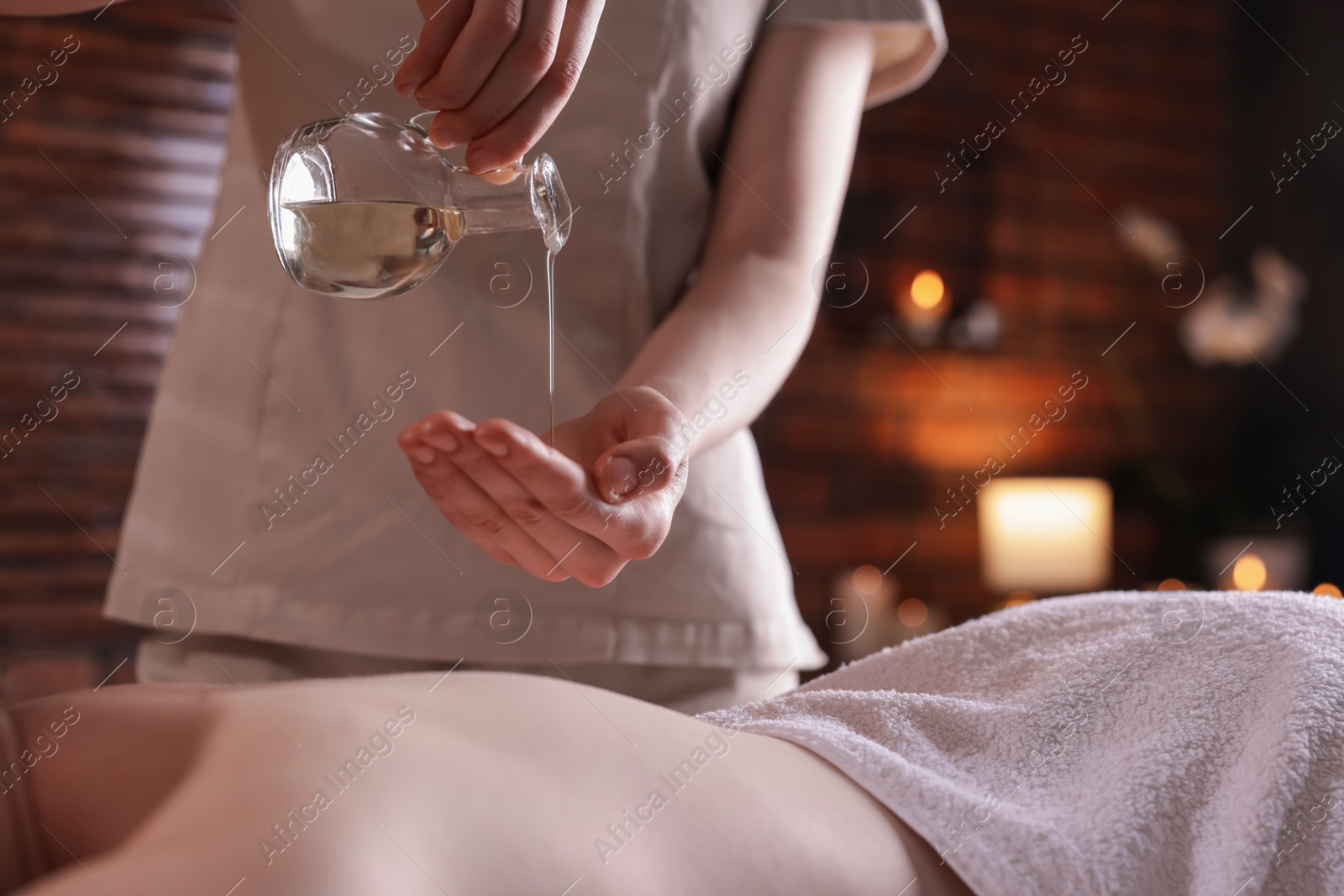 Woman receiving back massage with oil in spa salon, closeup Photo of Woman receiving back massage with oil in spa salon, closeup