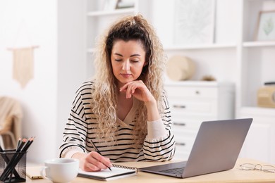 Photo of Woman working at desk in home office