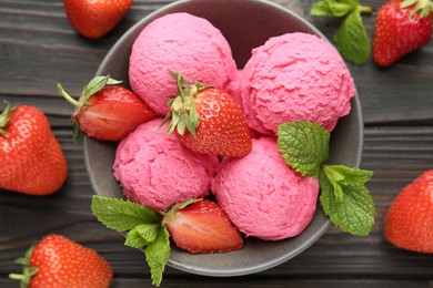 Photo of Tasty sorbet with strawberries and mint served on wooden table, flat lay