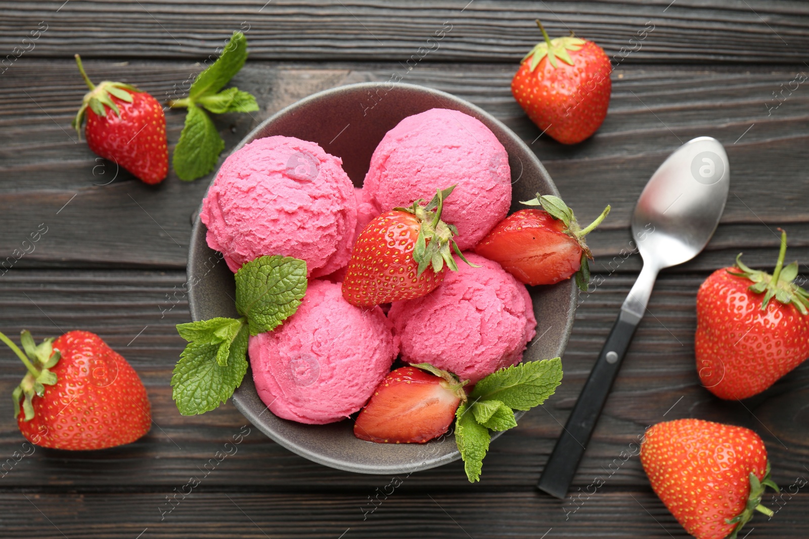 Photo of Tasty sorbet with strawberries and mint served on wooden table, flat lay