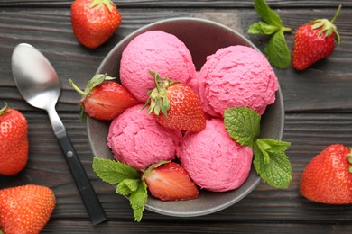 Photo of Tasty sorbet with strawberries and mint served on wooden table, flat lay