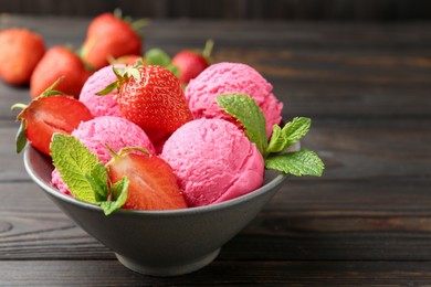 Photo of Tasty sorbet with strawberries and mint served on wooden table, closeup