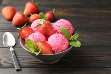 Photo of Tasty sorbet with strawberries and mint served on wooden table, closeup