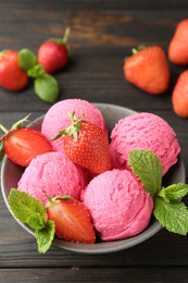 Photo of Tasty sorbet with strawberries and mint served on wooden table, closeup