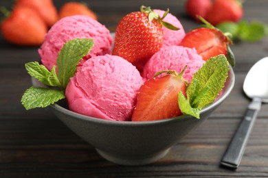 Photo of Tasty sorbet with strawberries and mint served on wooden table, closeup