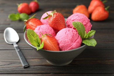Photo of Tasty sorbet with strawberries and mint served on wooden table, closeup