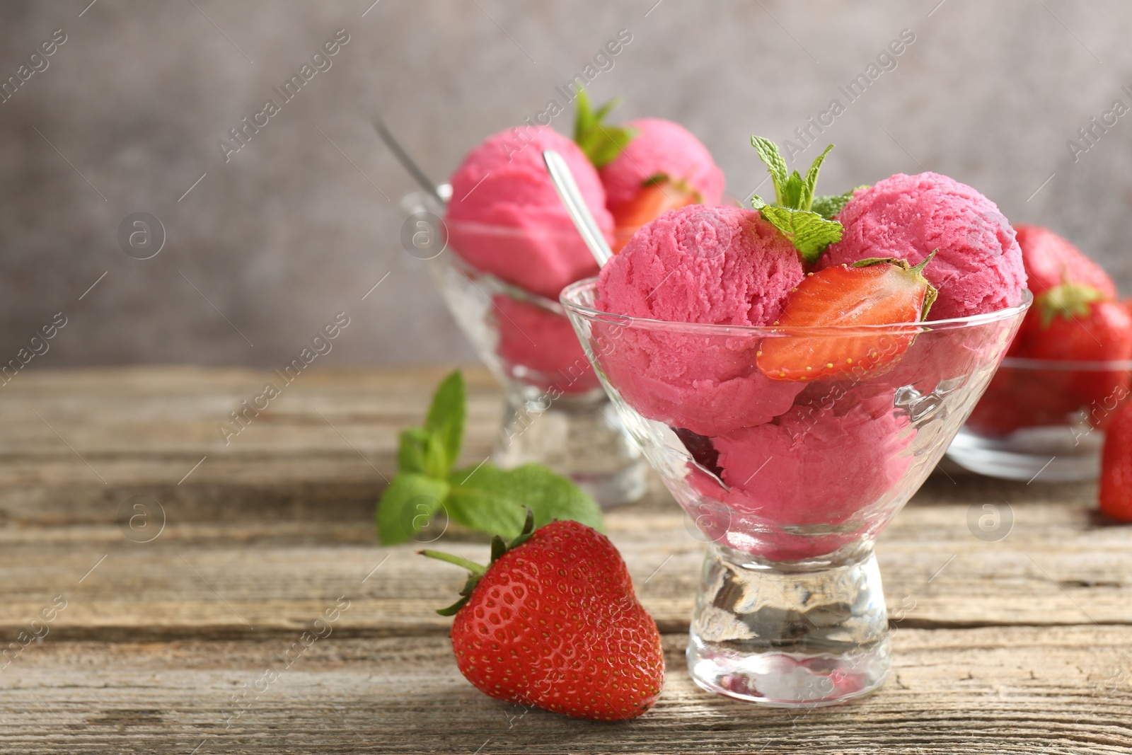 Tasty sorbet with strawberries and mint served on wooden table, closeup. Space for text Photo of Tasty sorbet with strawberries and mint served on wooden table, closeup. Space for text