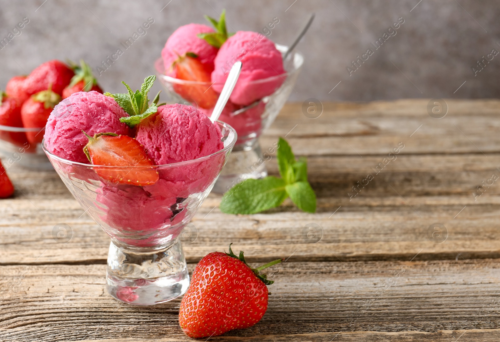 Tasty sorbet with strawberries and mint served on wooden table, closeup. Space for text Photo of Tasty sorbet with strawberries and mint served on wooden table, closeup. Space for text