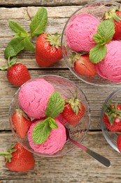 Photo of Tasty sorbet with strawberries and mint served on wooden table, flat lay