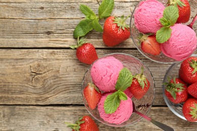 Photo of Tasty sorbet with strawberries and mint served on wooden table, flat lay. Space for text