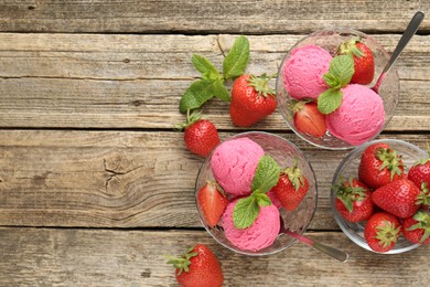 Photo of Tasty sorbet with strawberries and mint served on wooden table, flat lay. Space for text