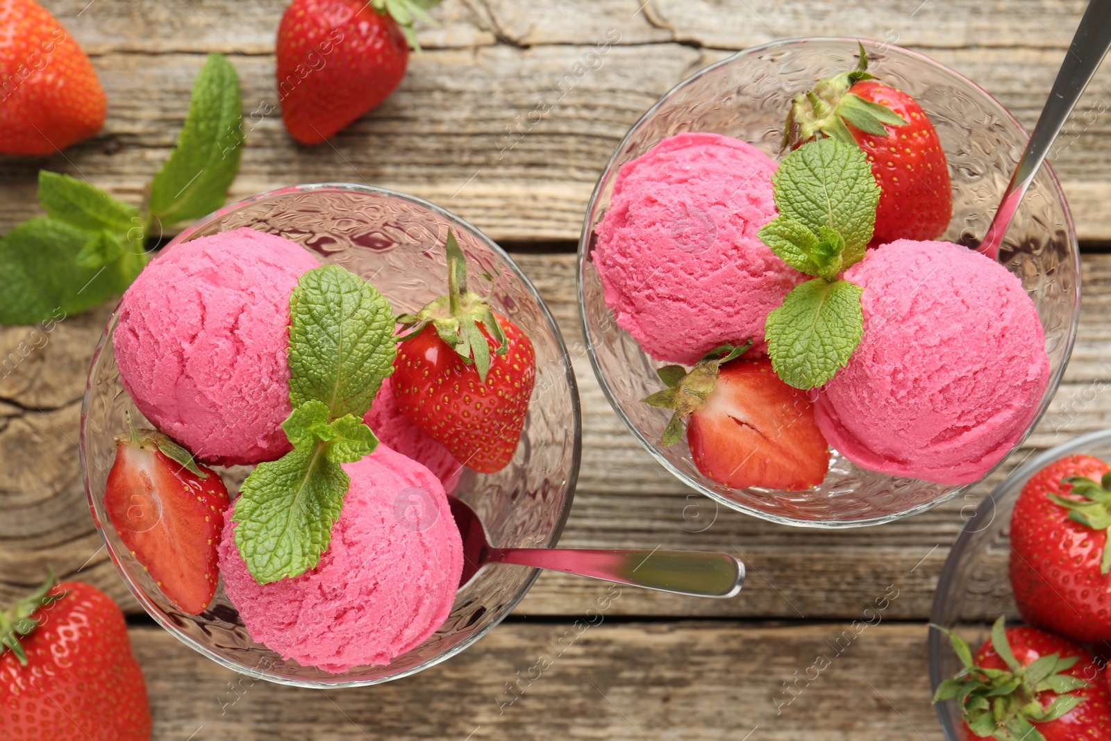Tasty sorbet with strawberries and mint served on wooden table, flat lay Photo of Tasty sorbet with strawberries and mint served on wooden table, flat lay