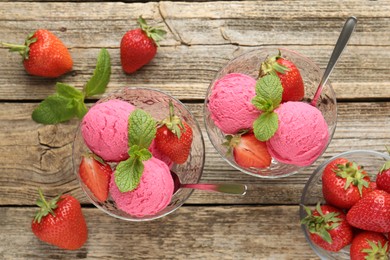 Photo of Tasty sorbet with strawberries and mint served on wooden table, flat lay