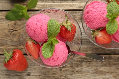 Photo of Tasty sorbet with strawberries and mint served on wooden table, flat lay