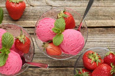 Photo of Tasty sorbet with strawberries and mint served on wooden table, flat lay