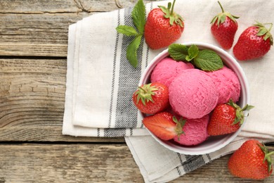 Photo of Tasty sorbet with strawberries and mint served on wooden table, flat lay. Space for text