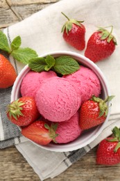 Photo of Tasty sorbet with strawberries and mint served on wooden table, flat lay