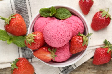 Photo of Tasty sorbet with strawberries and mint served on wooden table, flat lay