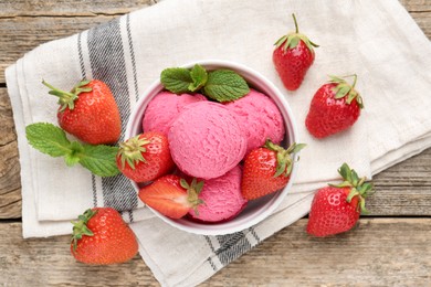 Photo of Tasty sorbet with strawberries and mint served on wooden table, flat lay