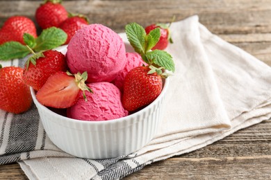 Photo of Tasty sorbet with strawberries and mint served on wooden table, closeup. Space for text