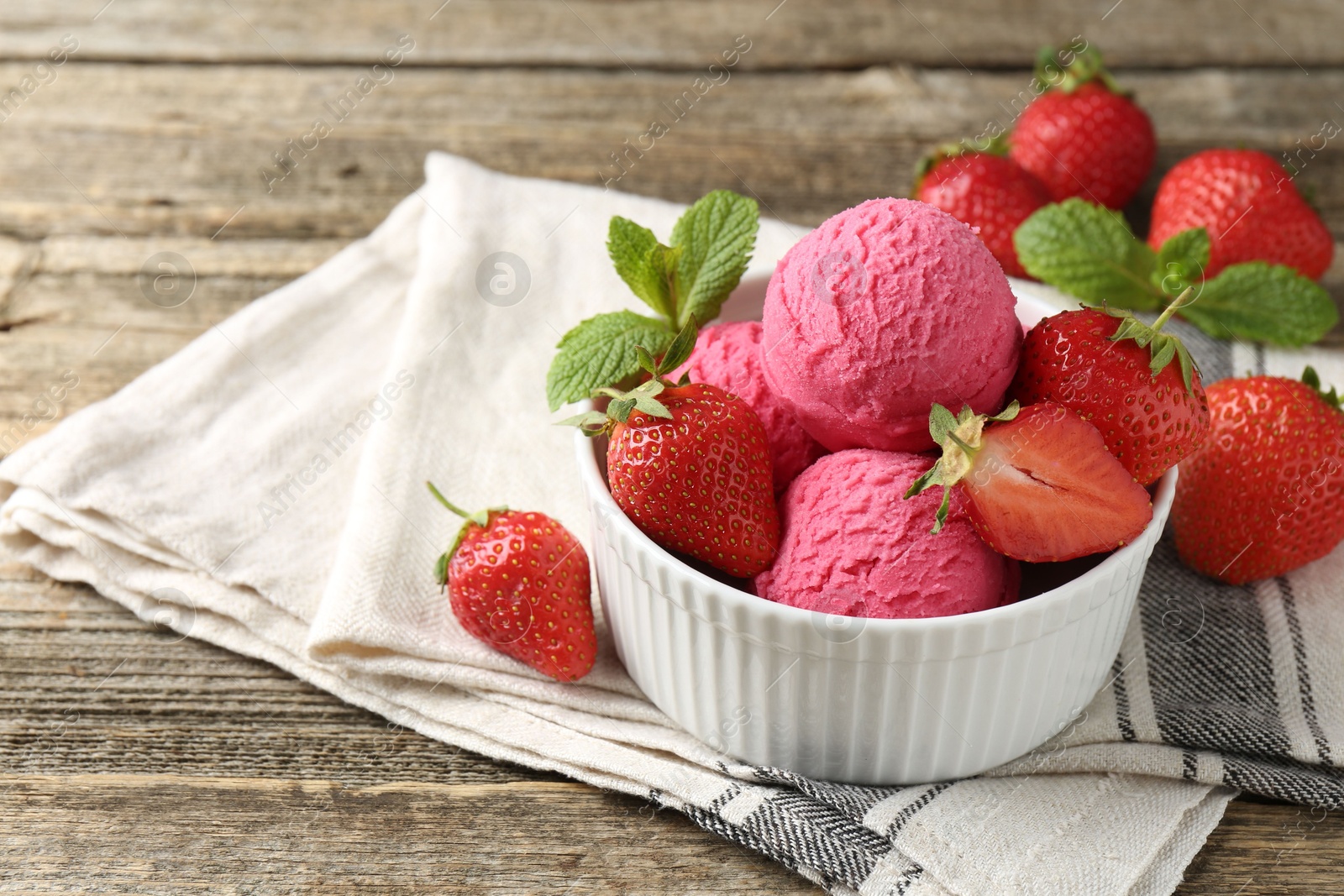 Tasty sorbet with strawberries and mint served on wooden table, closeup. Space for text Photo of Tasty sorbet with strawberries and mint served on wooden table, closeup. Space for text