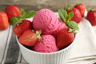 Photo of Tasty sorbet with strawberries and mint served on wooden table, closeup