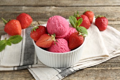 Photo of Tasty sorbet with strawberries and mint served on wooden table, closeup