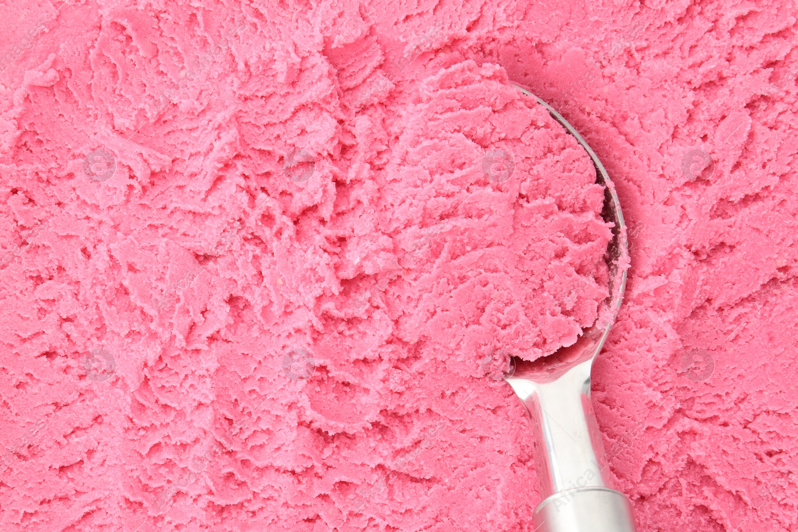 Tasty strawberry sorbet and spoon as background, top view Photo of Tasty strawberry sorbet and spoon as background, top view