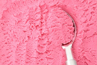 Photo of Tasty strawberry sorbet and spoon as background, top view