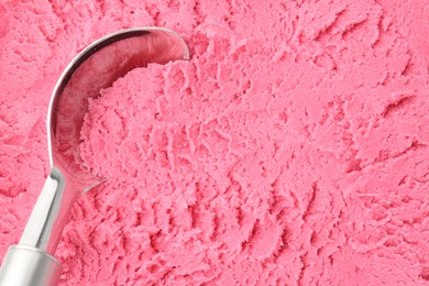 Photo of Tasty strawberry sorbet and spoon as background, top view
