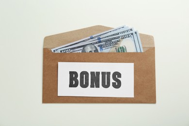 Image of Bonus. Envelope with dollar bills on white background, top view