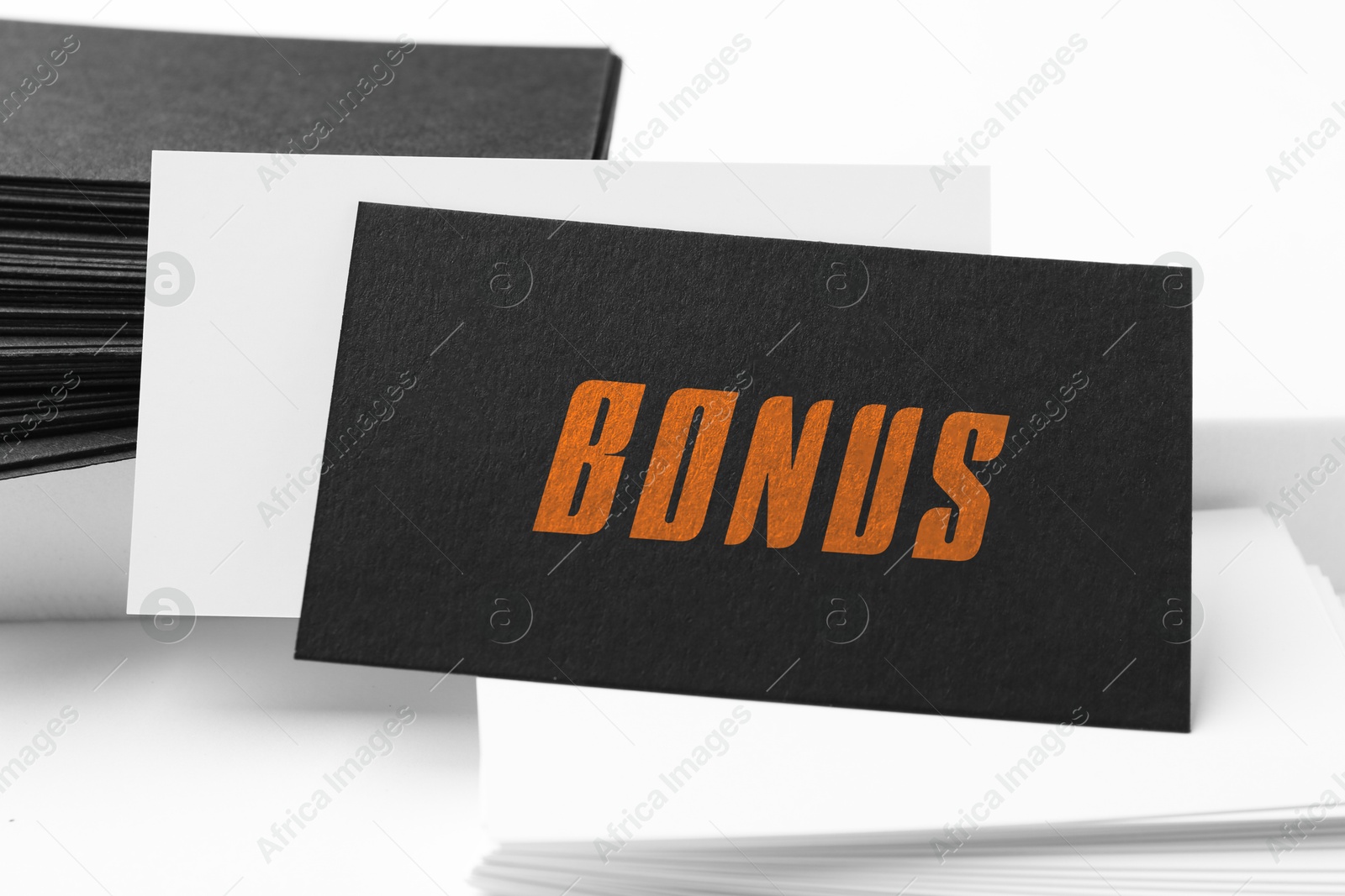 Black bonus card on white table, closeup Image of Black bonus card on white table, closeup