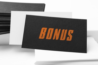 Image of Black bonus card on white table, closeup