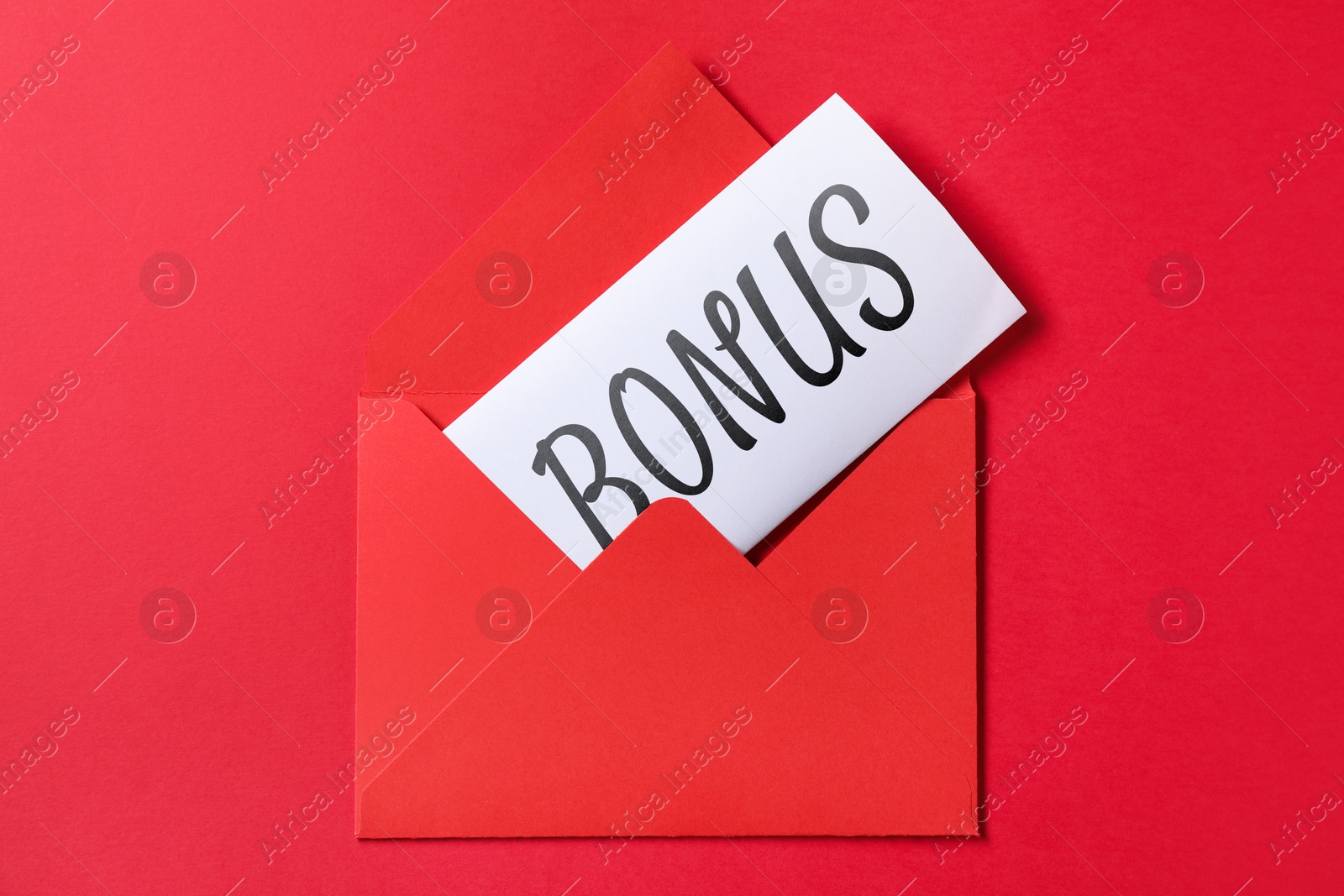 Card with word Bonus in envelope on red background, top view Image of Card with word Bonus in envelope on red background, top view