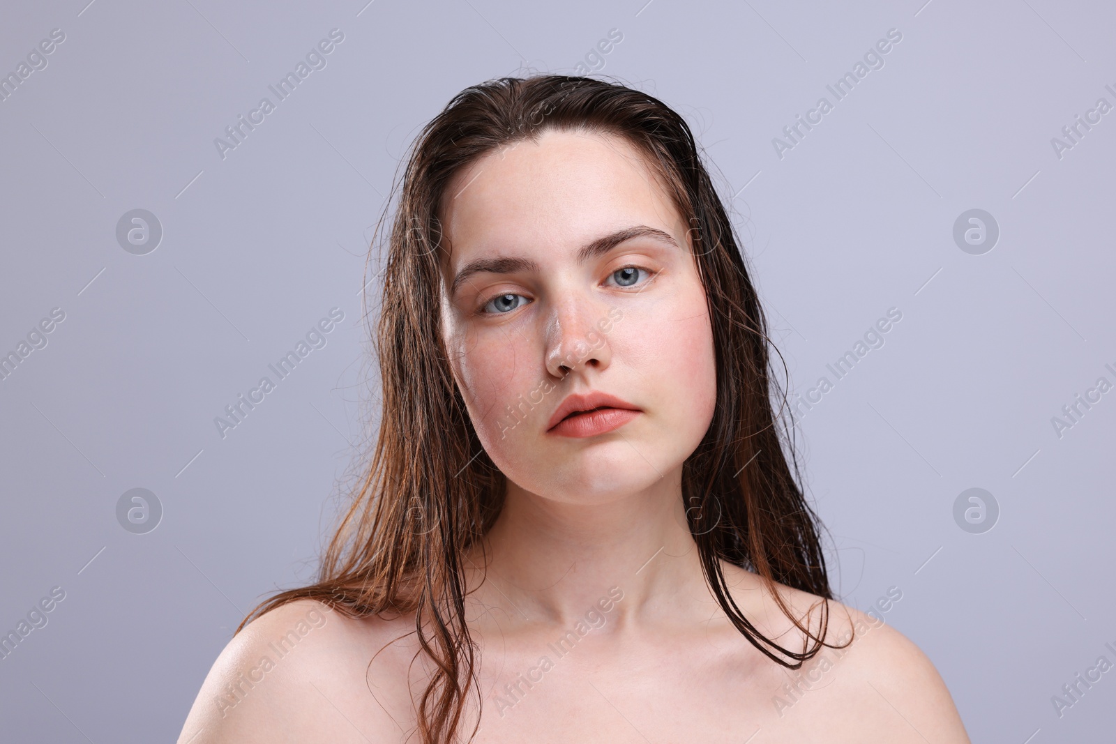 Portrait of woman with natural skin complexion on grey background, closeup Photo of Portrait of woman with natural skin complexion on grey background, closeup