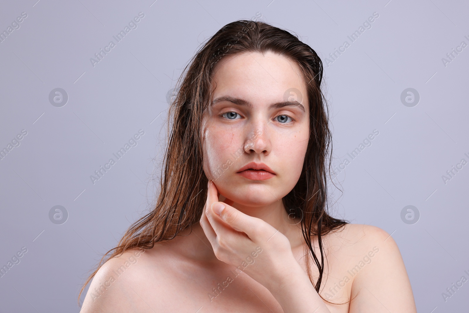 Portrait of woman with natural skin complexion on grey background, closeup Photo of Portrait of woman with natural skin complexion on grey background, closeup